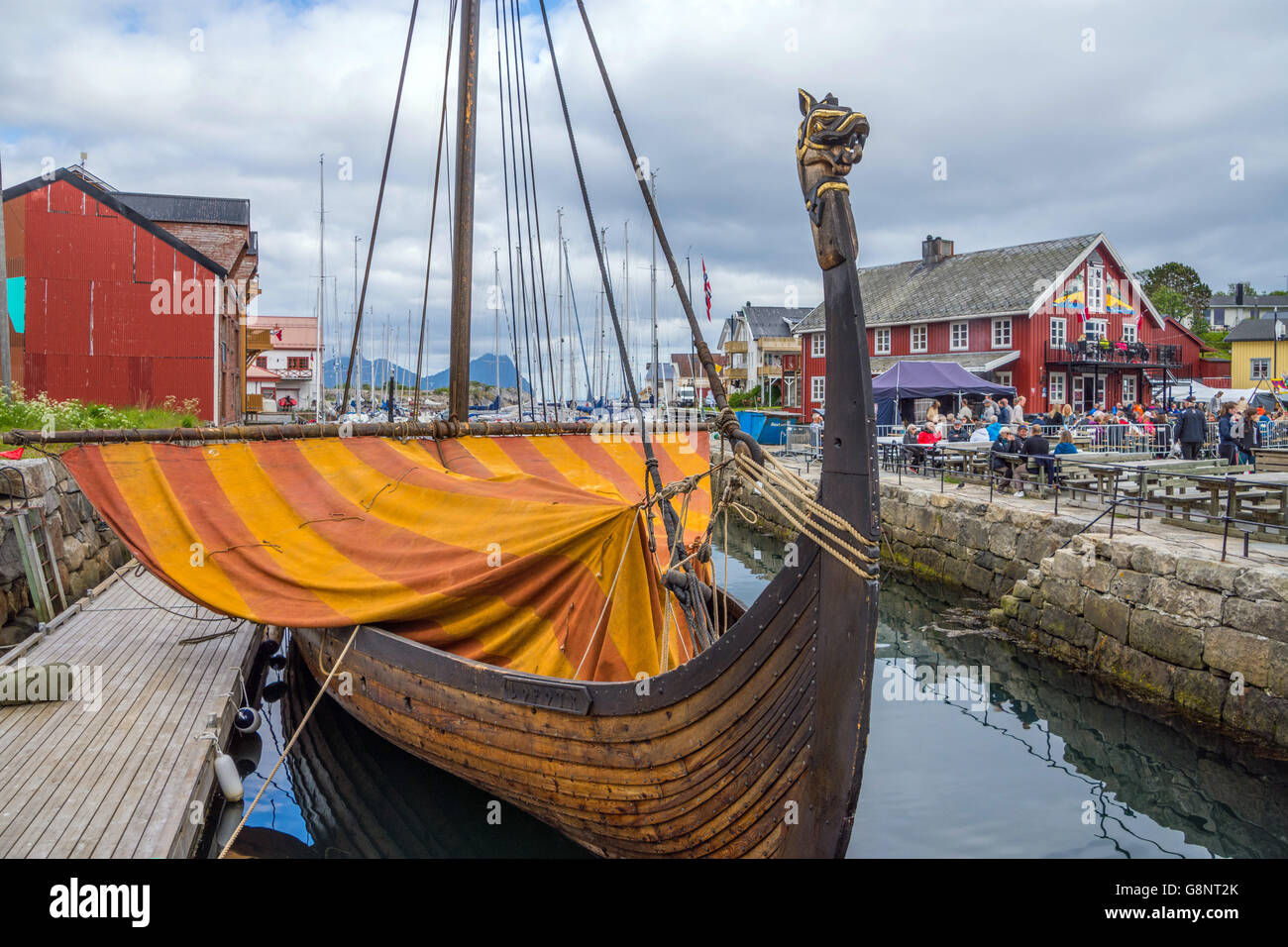 Lofotr (viking long-ship) reconstruction with orange sail, in harbour harbor, Kabelvag, Lofoten Islands, Norway Stock Photo