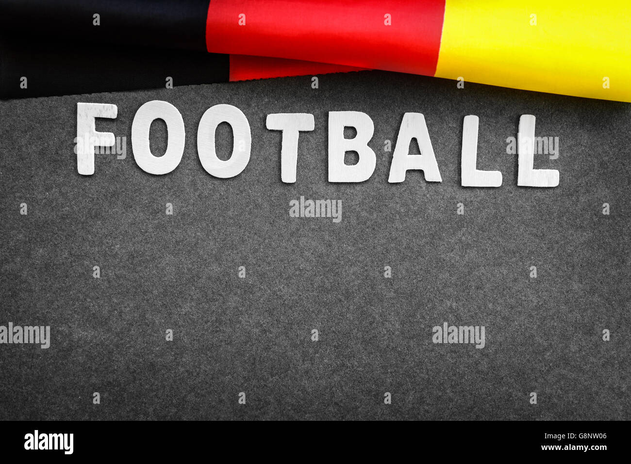 Gray background with word football and German flag on it, abstract football backdrop with text space, victory of the Germany Stock Photo