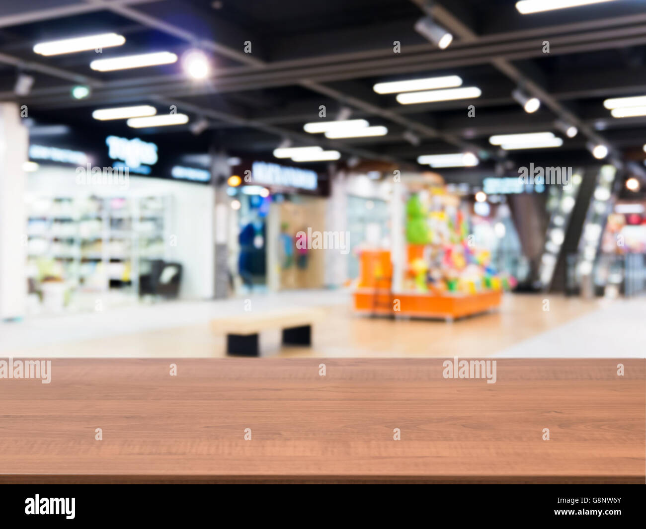 Wooden empty table in front of blurred mall Stock Photo