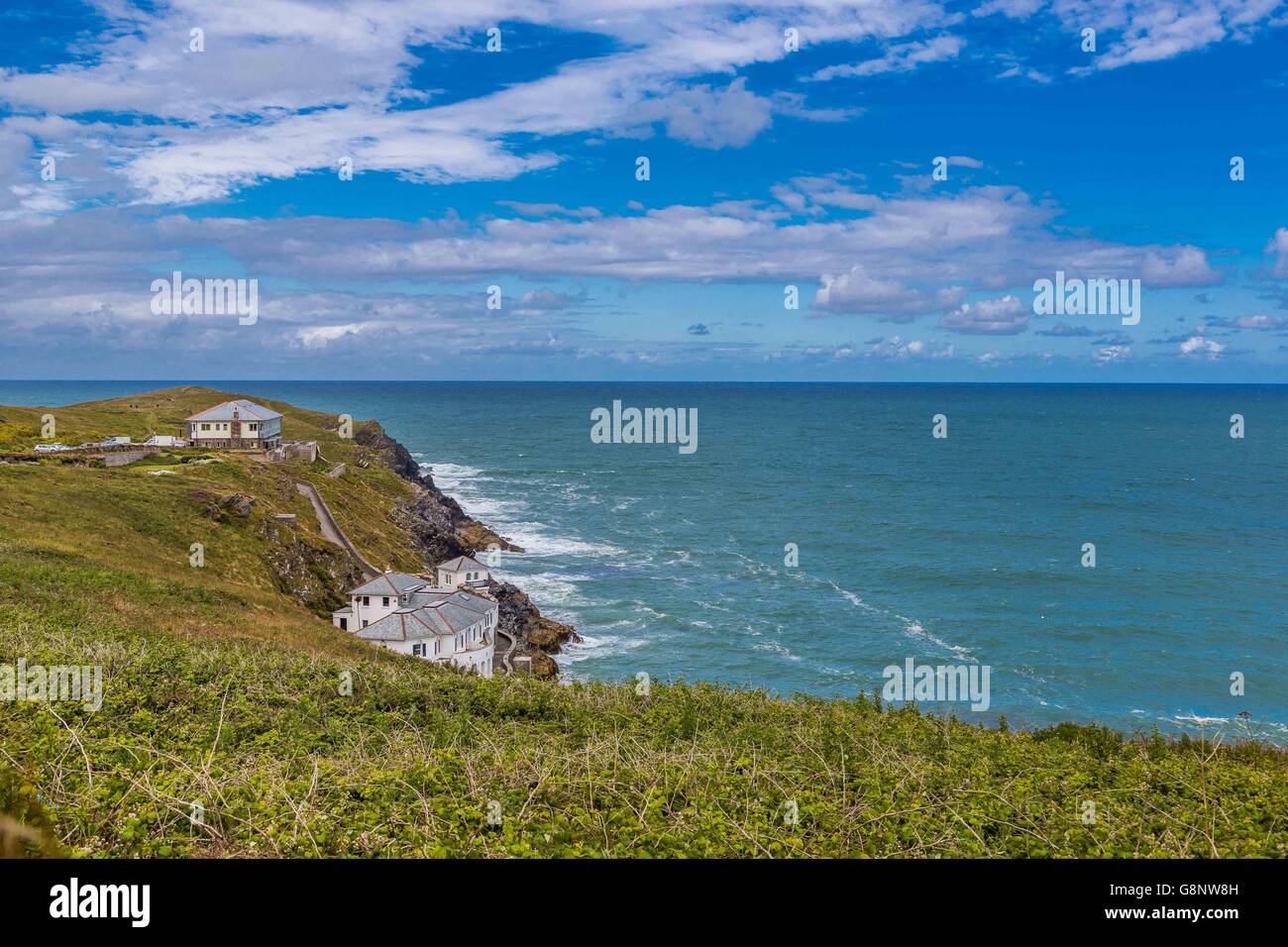 The Lewinnick Lodge at West Pentire waves and the blue sea ocean off the Cornish coast UK Stock Photo