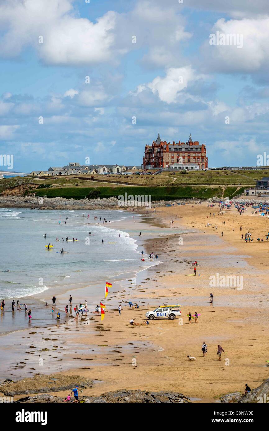 A crowd of people on the beach by the sea on Fistral Beach, Newquay, Cornwall, UK with the Headland Hotel behind Stock Photo