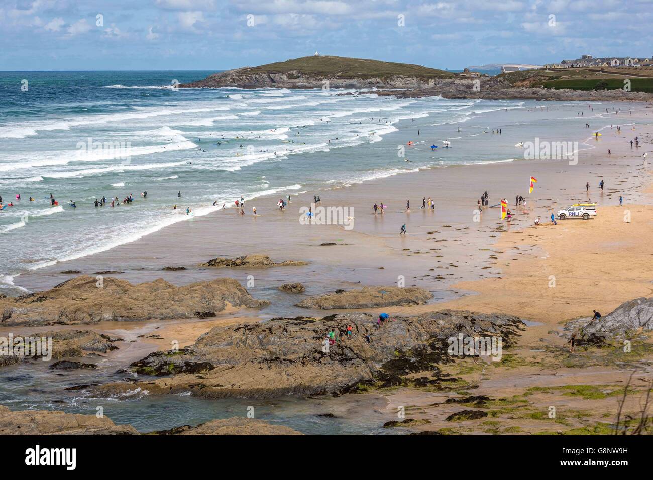 A crowd of people on the beach by the sea on Fistral Beach, Newquay, Cornwall, UK Stock Photo