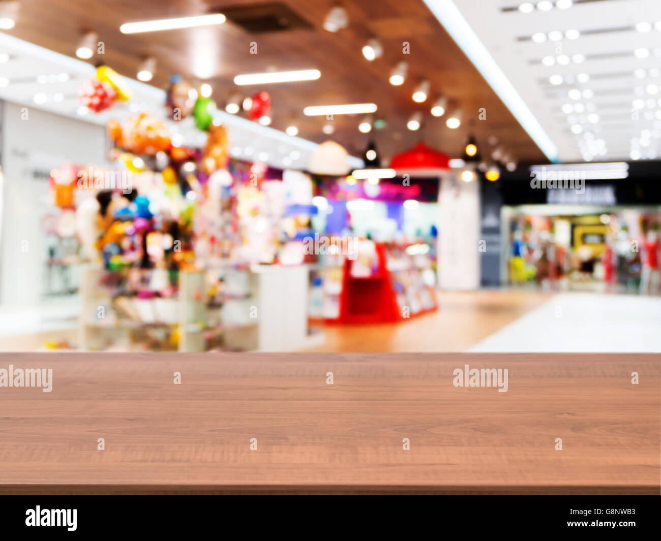 Wooden empty table in front of blurred mall Stock Photo - Alamy