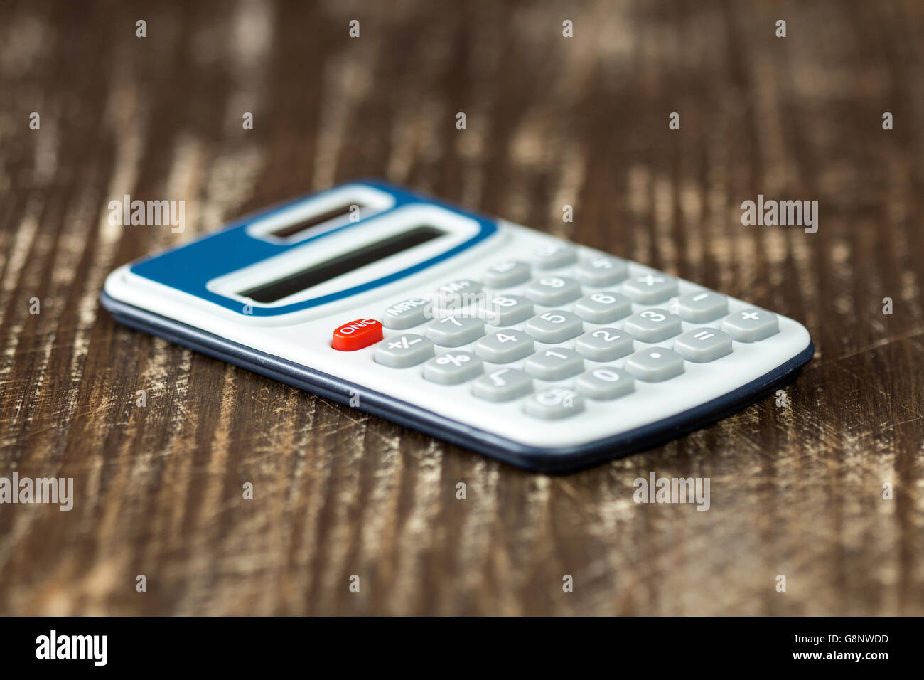 Electronic calculator on wooden background. Selective focus. Stock Photo