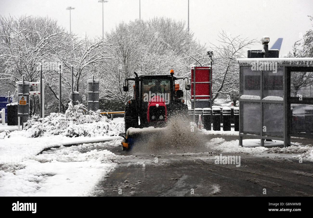 A tractor clears snow close to Leeds Bradford Airport which was forced to close while crews worked to clear the runway, as parts of the UK woke up to almost four inches of snow on Friday morning as March continues to feel more like winter than spring. Stock Photo