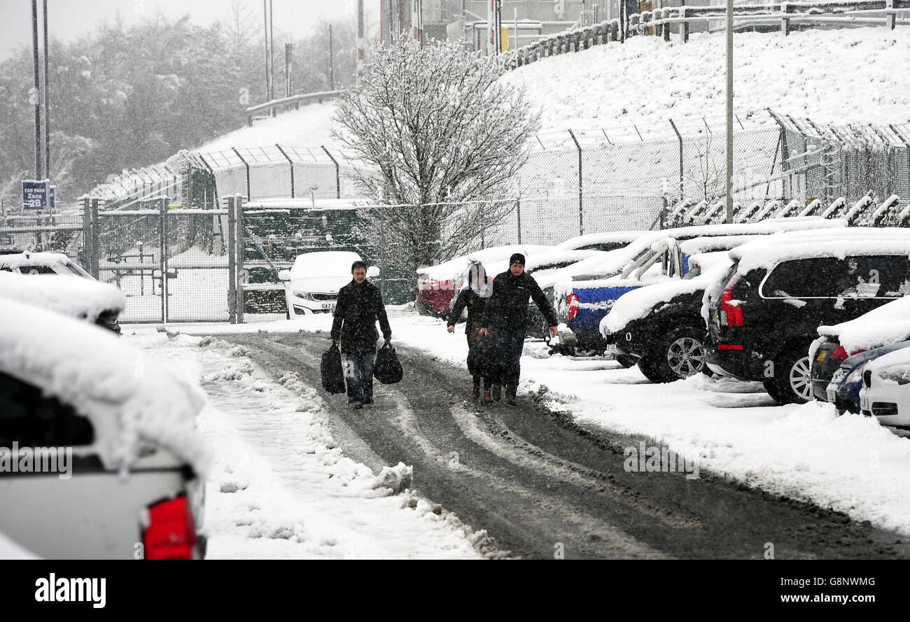 Passengers make their way through the snow to Leeds Bradford Airport which was forced to close while crews worked to clear the runway, as parts of the UK woke up to almost four inches of snow on Friday morning as March continues to feel more like winter than spring. Stock Photo
