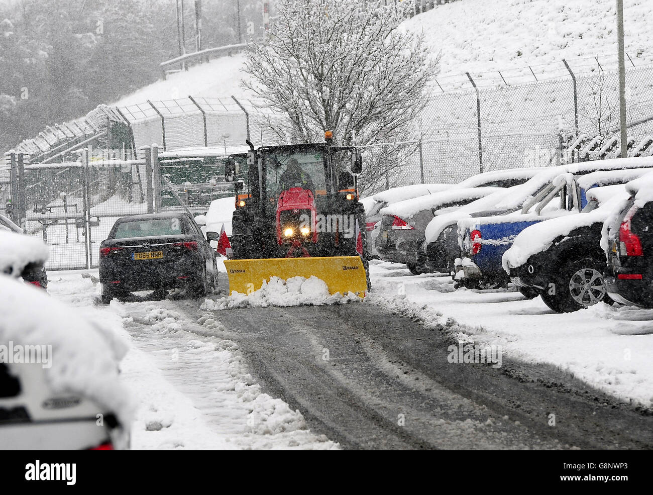 A tractor clears snow close to Leeds Bradford Airport which was forced to close while crews worked to clear the runway, as parts of the UK woke up to almost four inches of snow on Friday morning as March continues to feel more like winter than spring. Stock Photo