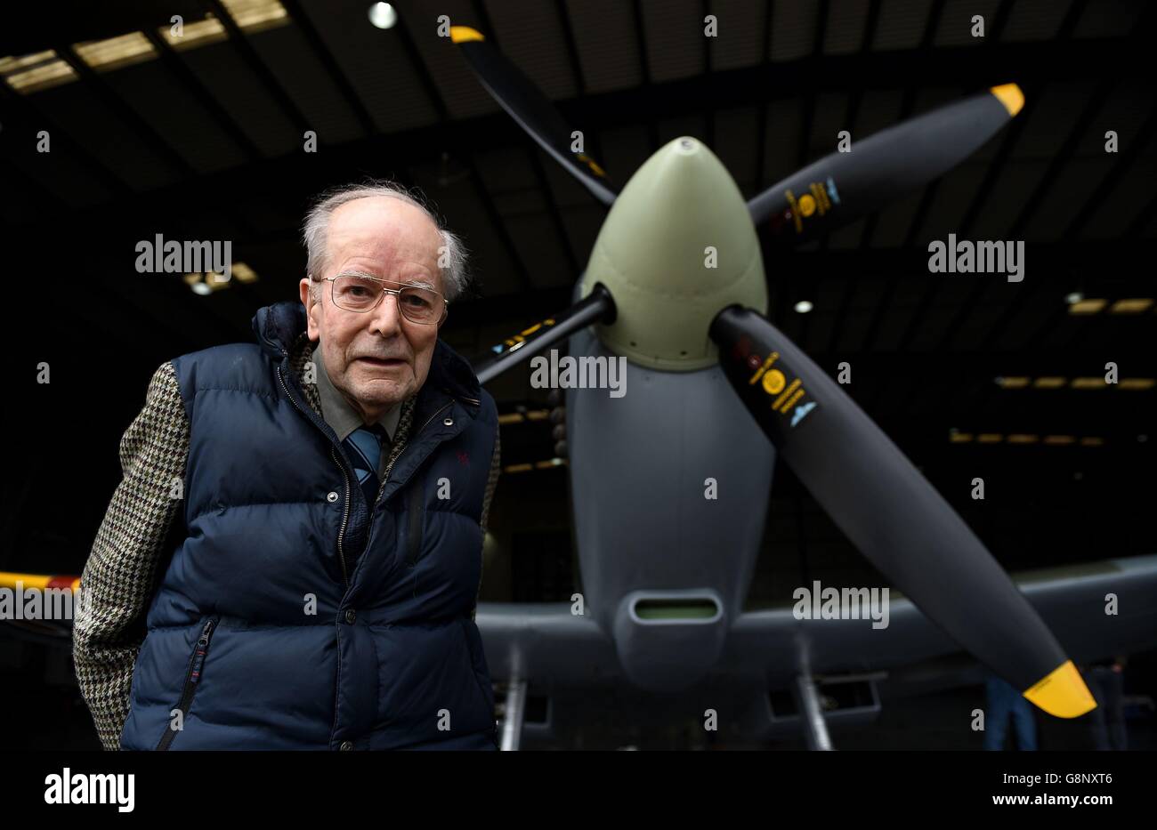 Gordon Monger, who was part of the Supermarine Spitfire design team during the Second World War, poses next to a spitfire before it prepares to take off from Southampton Airport to mark the 80th anniversary of the first Spitfire flight. Stock Photo