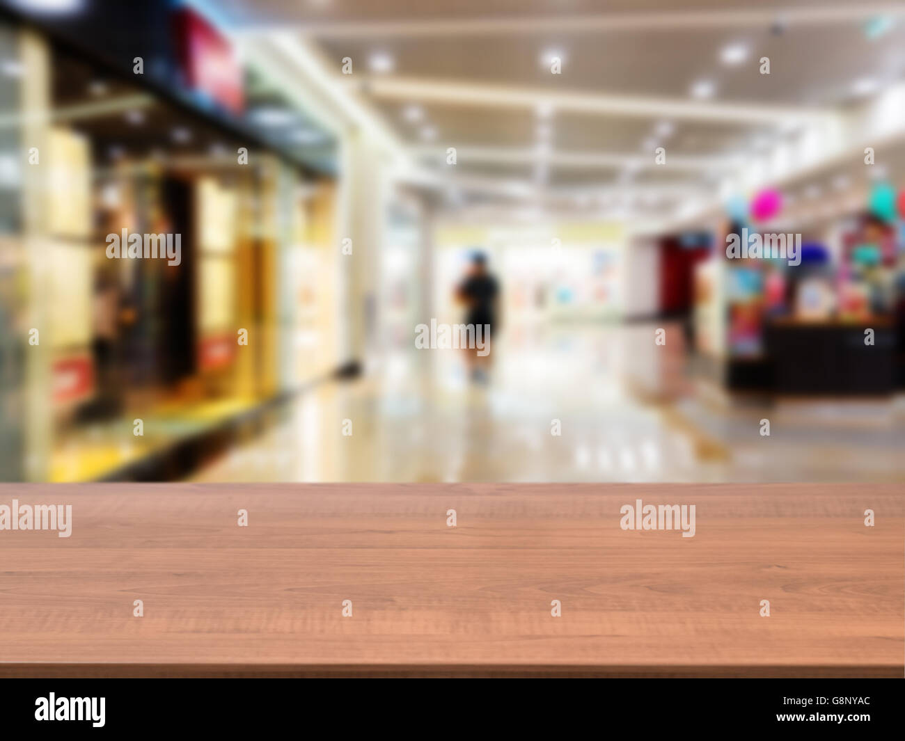 Wooden empty table in front of blurred mall Stock Photo - Alamy