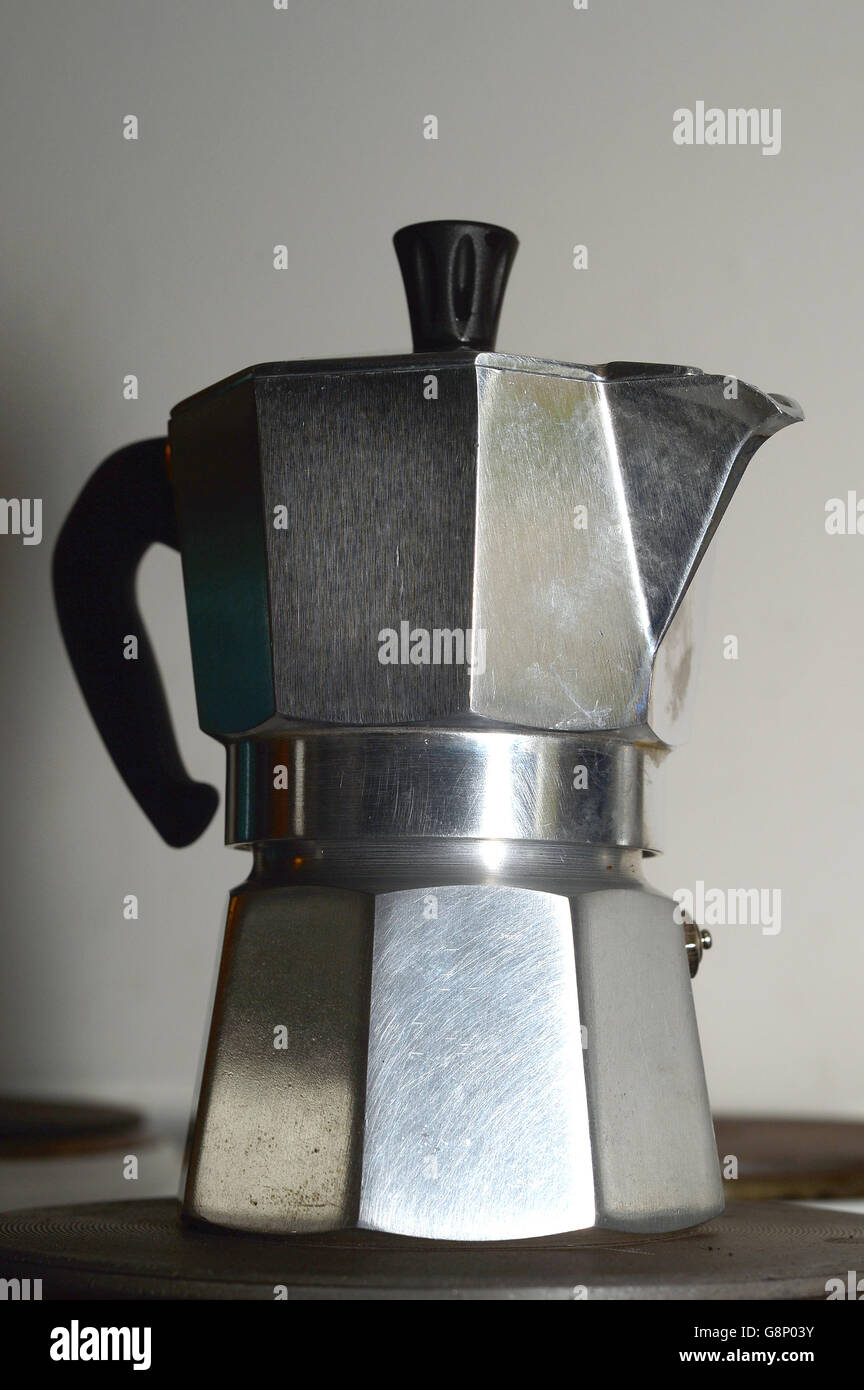 A stovetop espresso coffee maker on an electric hob, London Stock Photo