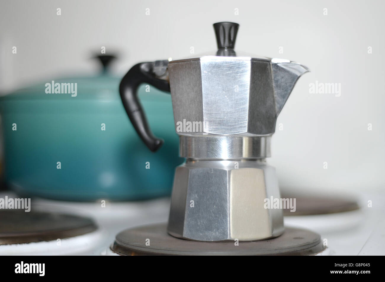 A stovetop espresso coffee maker on an electric hob, London Stock Photo