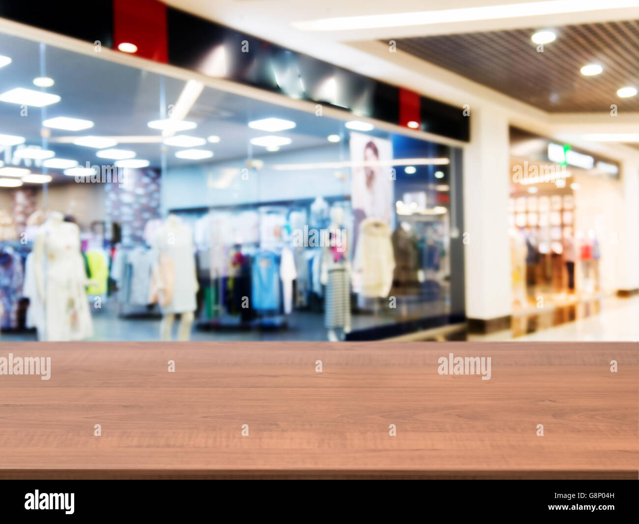 Wooden empty table in front of blurred mall Stock Photo - Alamy