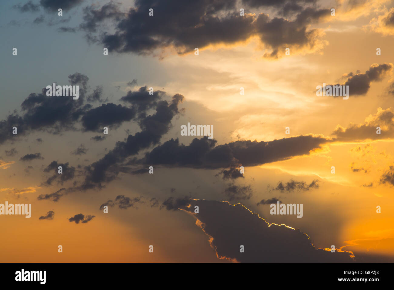 Sunset in dramatic sky with clouds in orange color tones Stock Photo ...