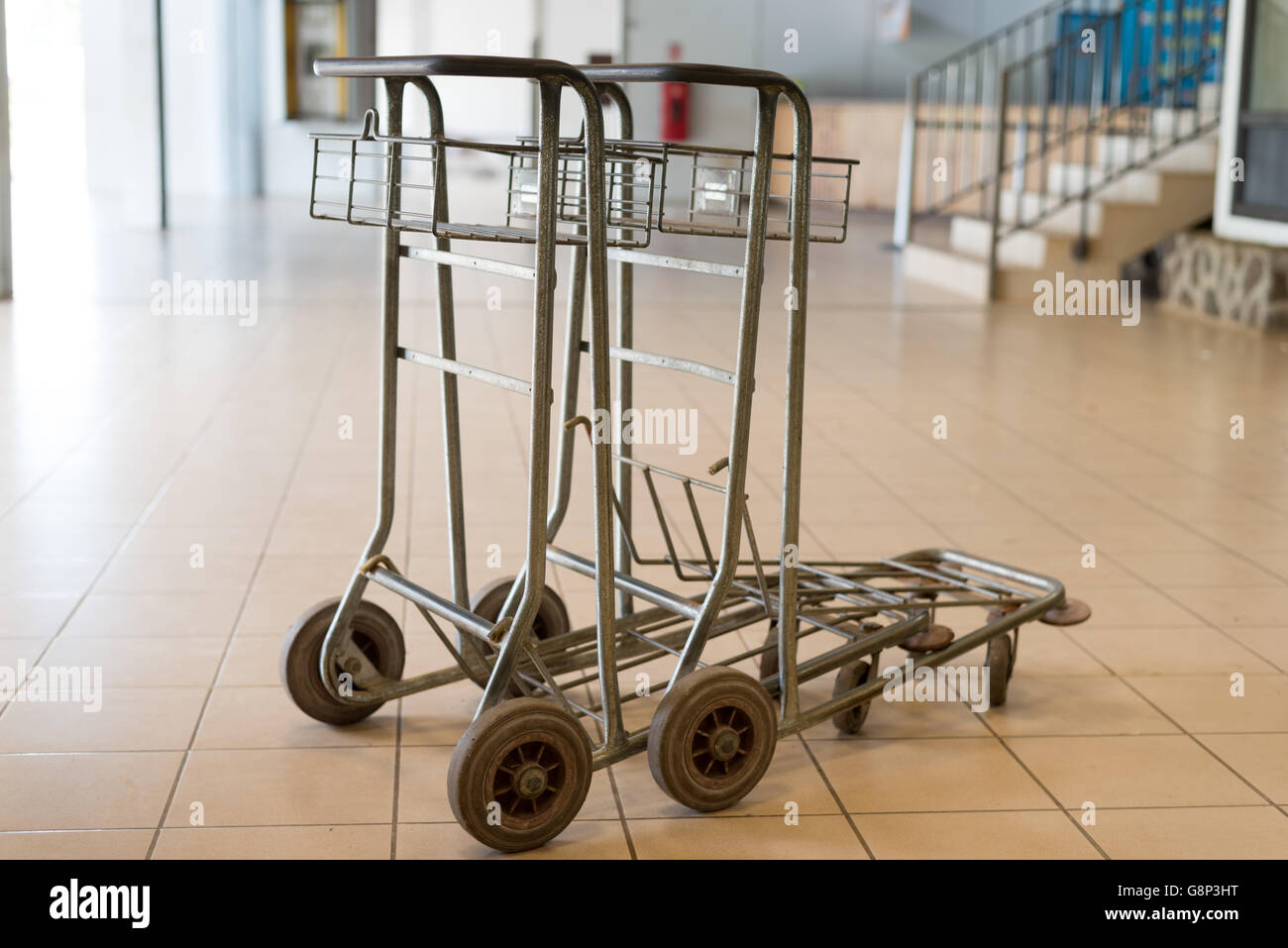 Two abandoned empty old airport luggage cart Stock Photo