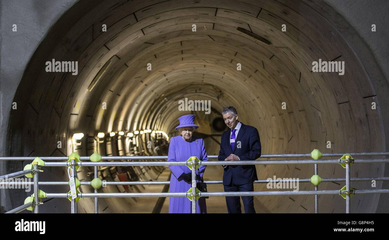 Queen Elizabeth II speaks with Mike Brown, London Transport Commissioner, at the tunnel entrance to one of the new platforms of the new Crossrail Bond Street station, which is still under construction. Stock Photo
