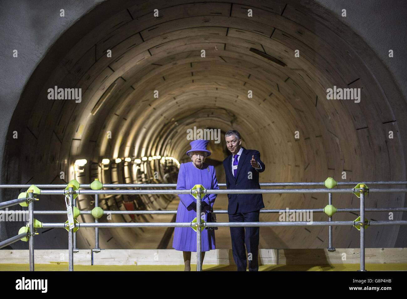 Queen Elizabeth II speaks with Mike Brown, London Transport Commissioner, at the tunnel entrance to one of the new platforms of the new Crossrail Bond Street station, which is still under construction. Stock Photo