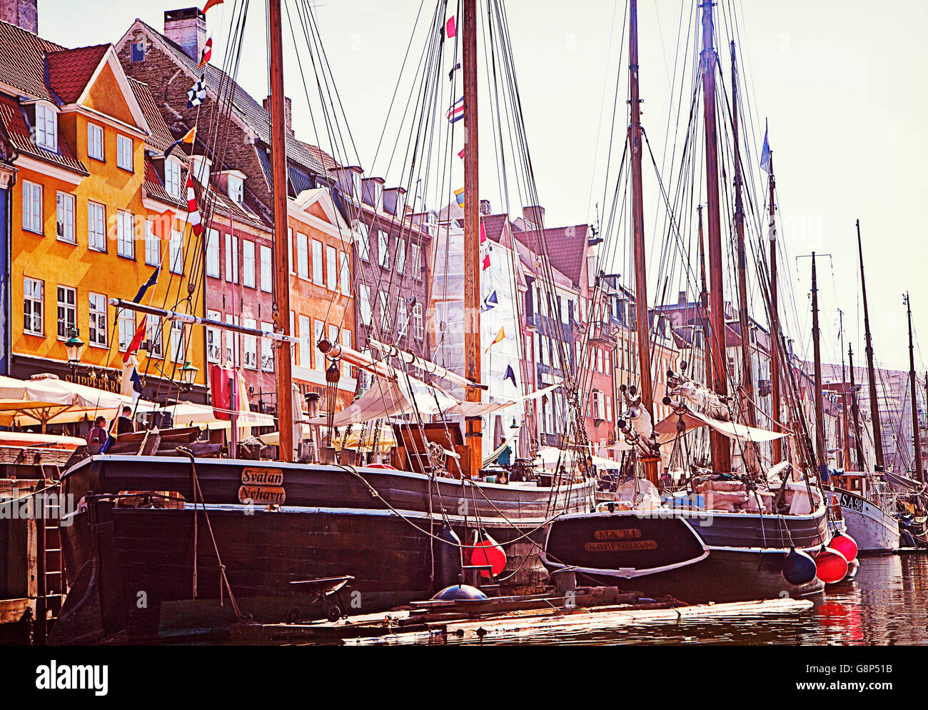 Copenhagen, panoramic view of Nyhavn harbor,  famous landmark and entertainment district with antique buildings and ships Stock Photo