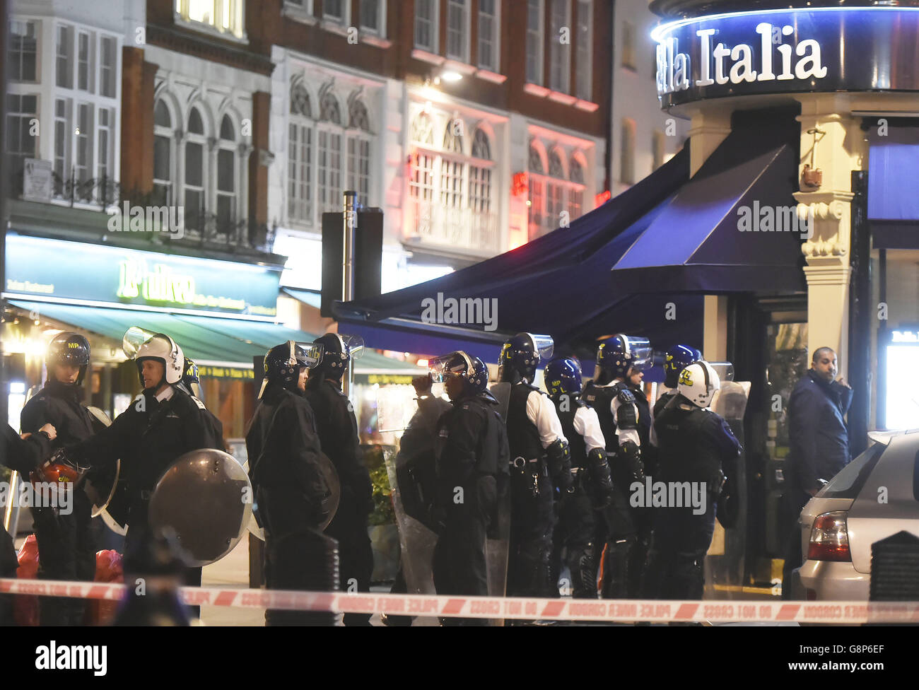 Police outside a branch of Bella Italia in Leicester Square, London, after a man took a woman hostage with a knife in a restaurant. Stock Photo
