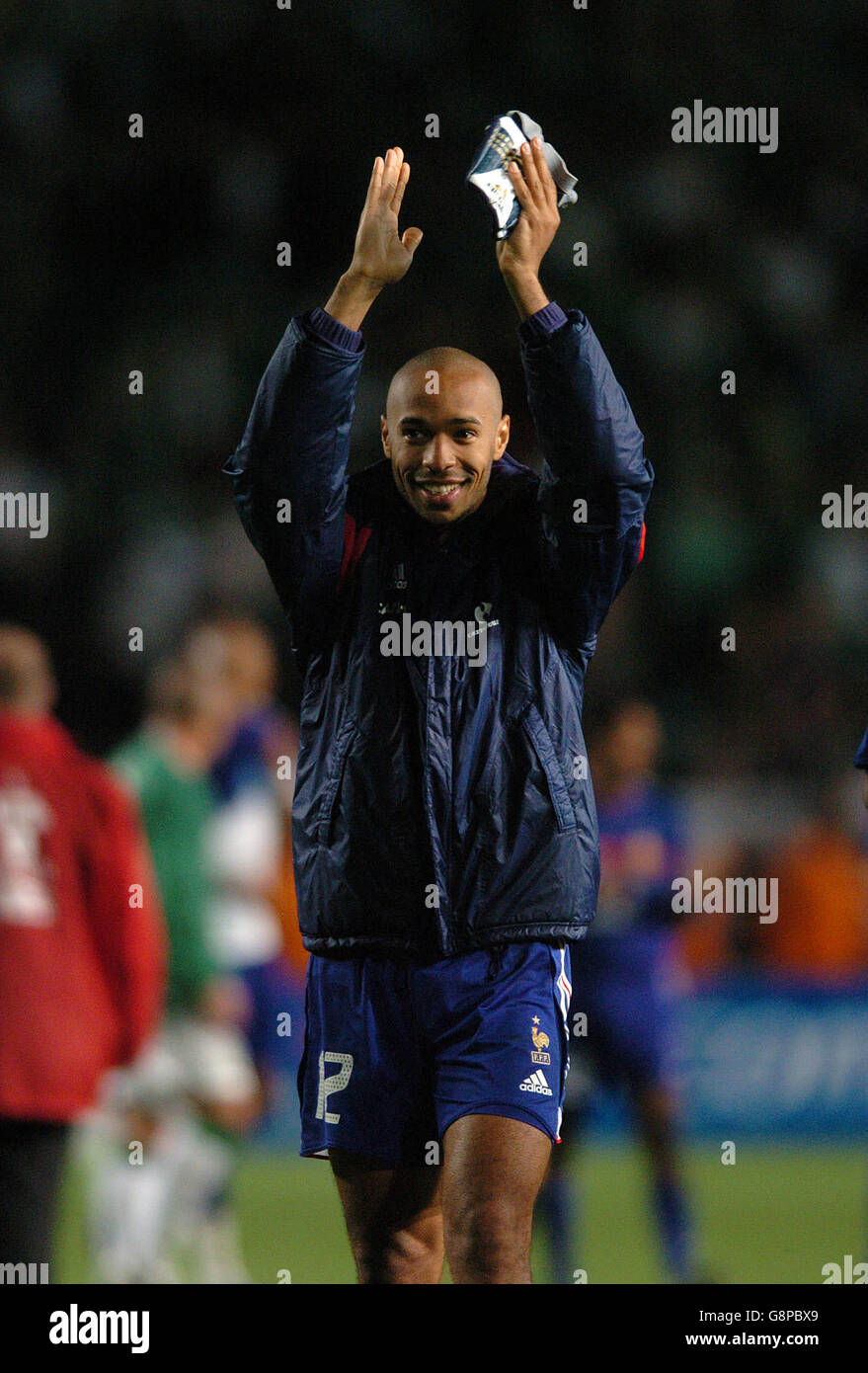 France's Thierry Henry smiles to the French fans at the end of the match Stock Photo