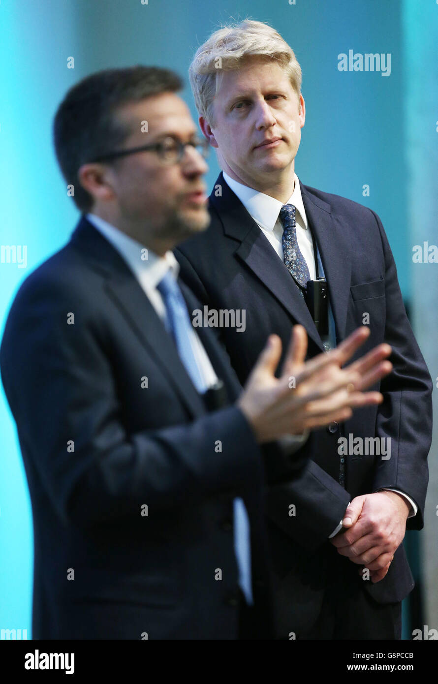 Universities Minister Jo Johnson (right) listens as Carlos Moedas EU Commissioner for Research Science and Inovation, speaks at the Babbage Lecture Theatre, University of Cambridge in Cambridge. Stock Photo