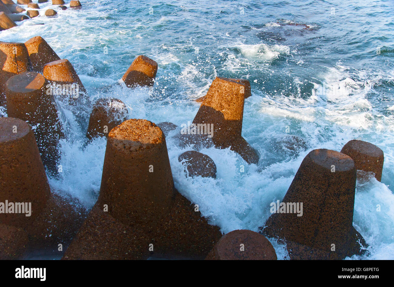Blue Ocean Waves Crashing on Shore Rocks Stock Photo