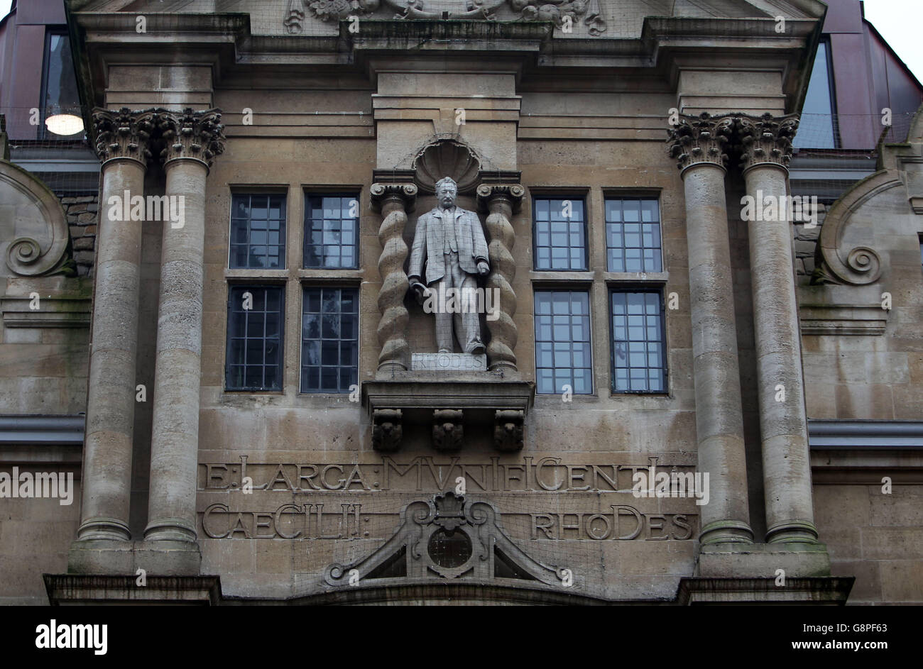 The statue mounted on Oriel college building of British imperialist Cecil Rhodes, as students march through Oxford, calling for its removal. Stock Photo