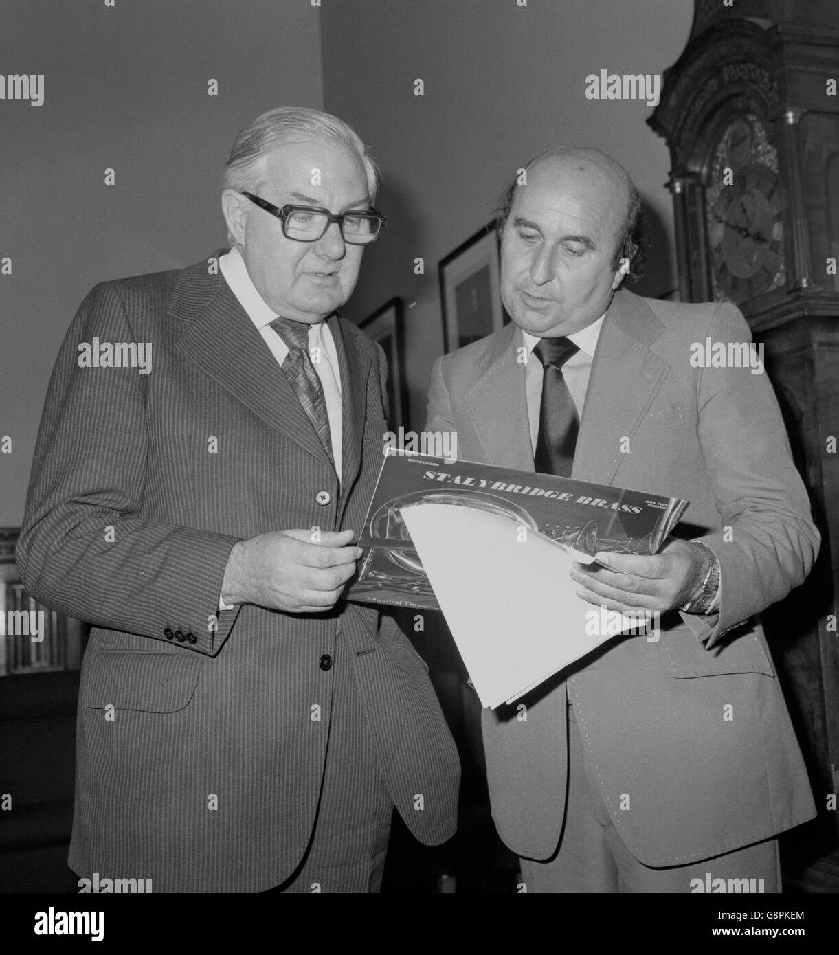 Prime Minister James Callaghan looking at the sleeve notes of an LP record, made by the Stalybridge Band after it was presented to him at the House of Commons by Tom Pendry (r), MP for Stalybridge and Hyde. Stock Photo