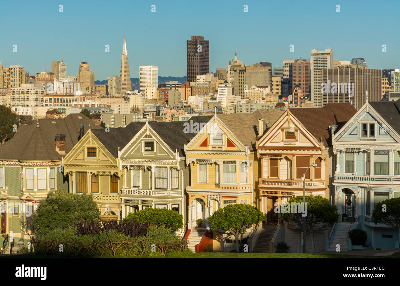 San Francisco California Painted Ladies Victorian homes and city in background at Alamo Square at Hayes Street and Steiner Stree Stock Photo
