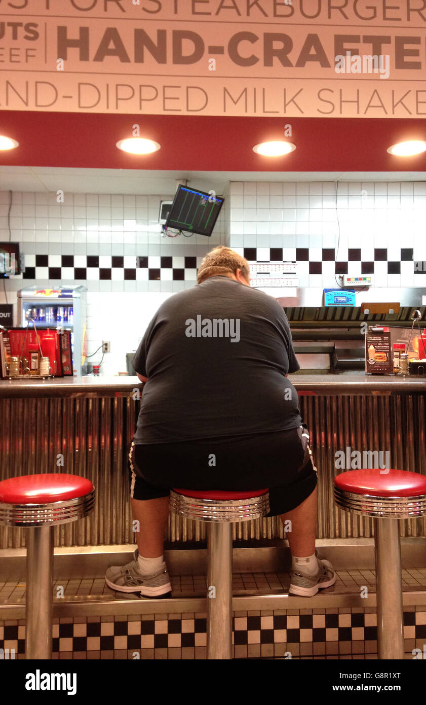 Fat obese man graphic image at a fast food diner on stool at counter
