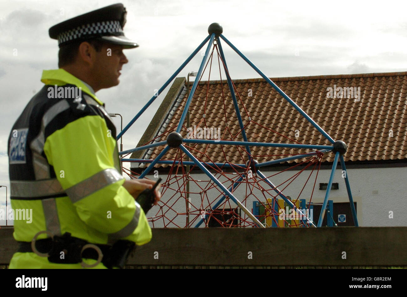 A policeman stands by a children's play area near where a fifteen year old boy was found dead today at Kestrel Brae Swing Park in Livingston, Thursday 8 September 2005. Danny Lawson. The grim find was made by a member of the public in Livingston, West Lothian, at 6am, said police. It is thought that the unidentified boy, who is aged between 10 and 14, may have been hanged in the park at Kestrel Brae. See PA Story POLICE Schoolboy. PRESS ASSOCIATION Photo. Photo credit should read: Danny Lawson /PA Stock Photo