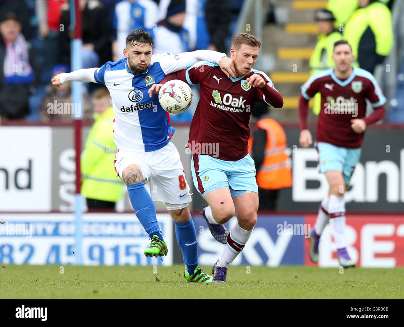 Blackburn Rovers' Tony Watt (left) and Burnley's Rouwen Hennings battle for the ball during the Sky Bet Championship match at Turf Moor, Burnley. Stock Photo