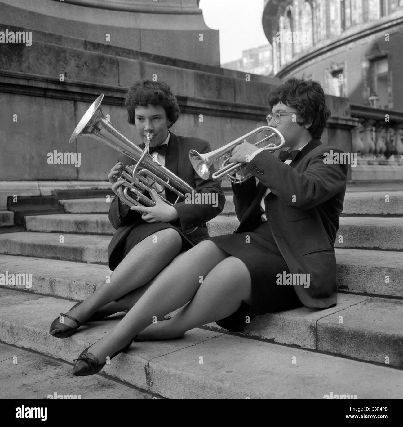 Susan Whiteman (l), 18, a baritone player, and Linda Trethewey, 16, a cornetist, of the St Dennis Silver Band, Cornwall, chose the steps for an impromptu rehearsal before competing in the National Brass Band Championships at the Royal Albert Hall, London. Stock Photo