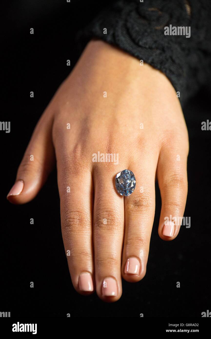 A member of Sotheby's staff holds the De Beers Millennium Jewel, a 10.10 carat 'internally flawless' blue diamond, which is the largest of its type to appear at auction and is estimated to fetch $30 to $35 million when it is sold in Sotheby's Hong Kong Magnificent Jewels and Jadeite Sale on 5 April 2016. Stock Photo
