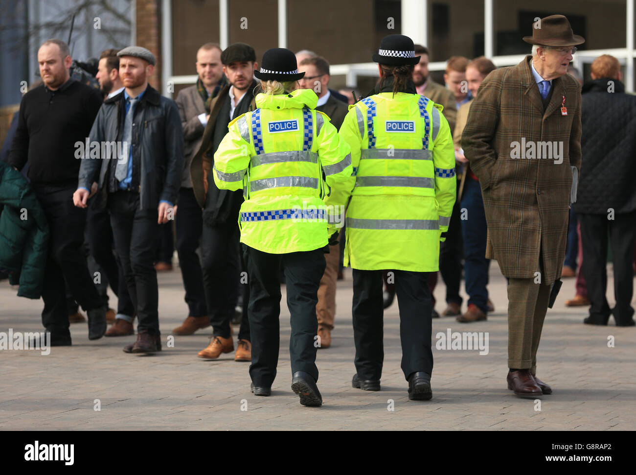 Police officers keeping tabs on proceedings during Champion Day of the 2016 Cheltenham Festival at Cheltenham Racecourse. Stock Photo