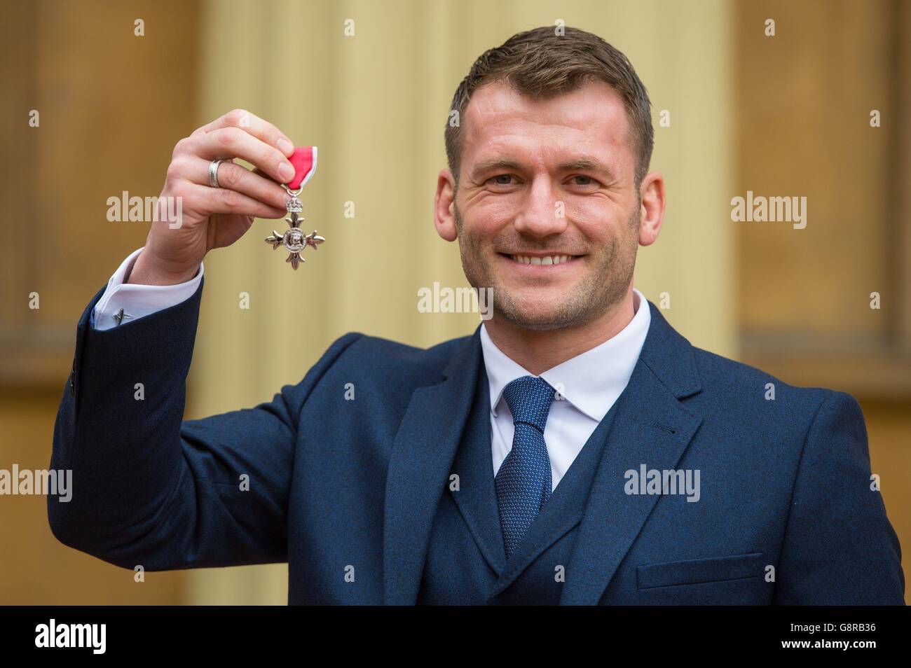 Rugby player Mark Cueto holds his Member of the British Empire (MBE) medal which was awarded by the Duke of Cambridge at an investiture ceremony at Buckingham Palace, London. Stock Photo