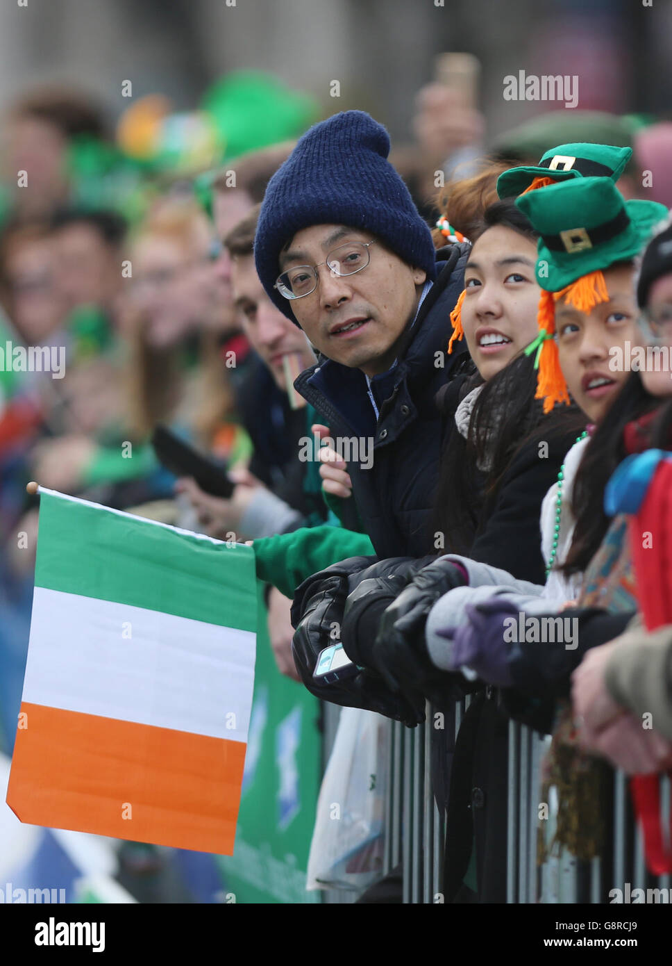 The crowd waits for the start of the St Patrick's Day parade on the streets of Dublin. Stock Photo