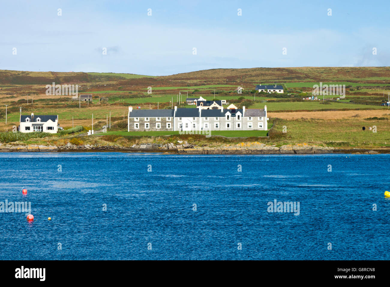 Houses on the shoreline of Valentia Island opposite the harbour of Portmagee in County Kerry Ireland, Europe. Stock Photo