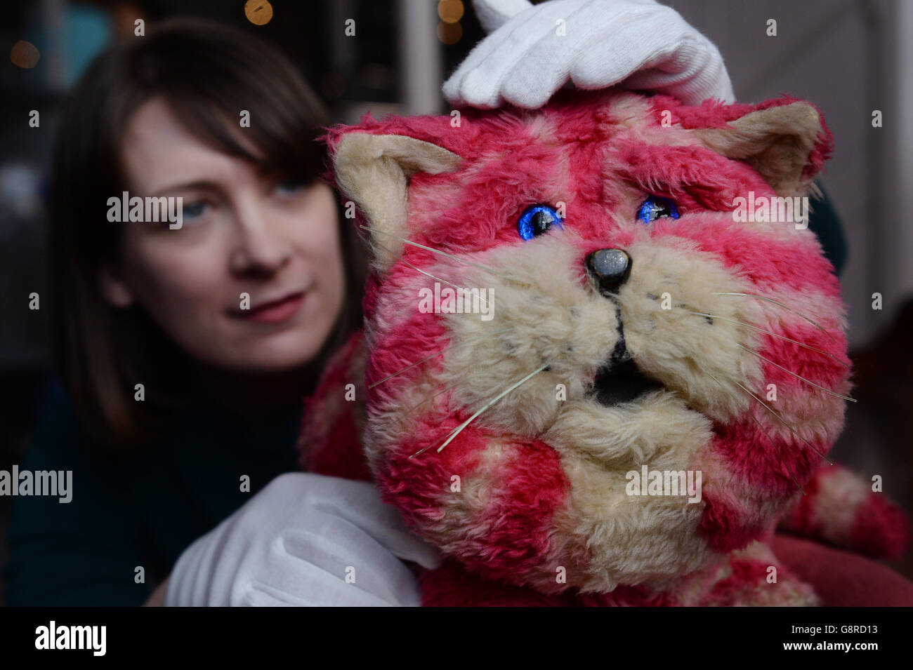 Alice Sage, Curator at the V&A Museum of Childhood in east London with Bagpuss, the original puppet used in the filming of the 1970s children's TV show which has gone on display as part of an exhibition called Clangers, Bagpuss and Co. Stock Photo