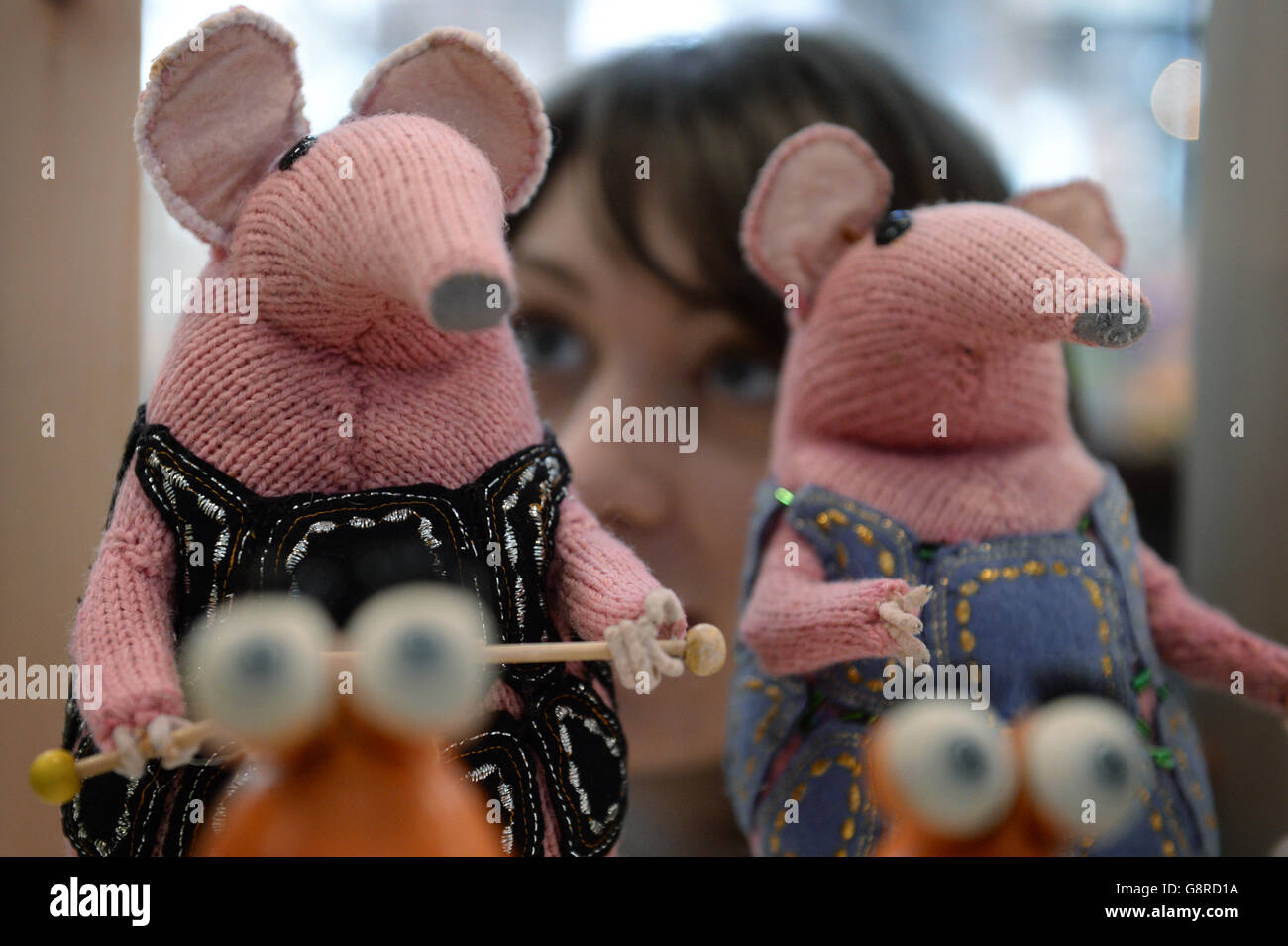 Alice Sage, Curator at the V&A Museum of Childhood in east London with two of the original Clanger puppets used in the filming of the 1970s children's TV show which has gone on display as part of an exhibition called Clangers, Bagpuss and Co. Stock Photo