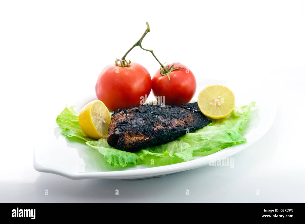 Grilled Tilapia with Salad on White Stock Photo Alamy