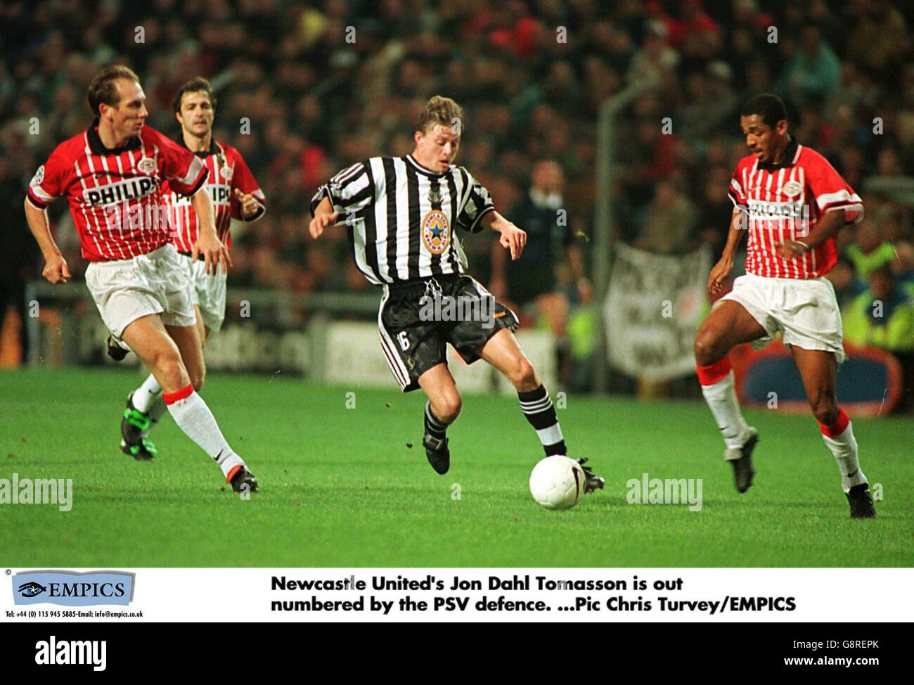 Newcastle United's Jon Dahl Tomasson (centre) runs at PSV Eindhoven's Vampeta (right) and Jaap Stam (left) Stock Photo