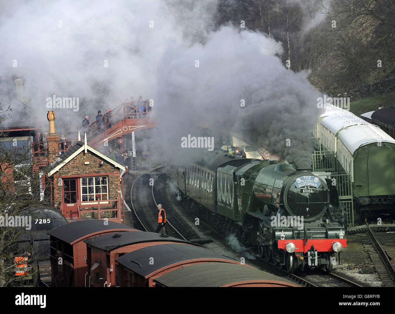The Flying Scotsman steams through Goathland station, made famous in the Heartbeat TV series, in the North York Moors National Park, on its way from Grosmont to Pickering on its first day on the North Yorks Moors Railway. Stock Photo