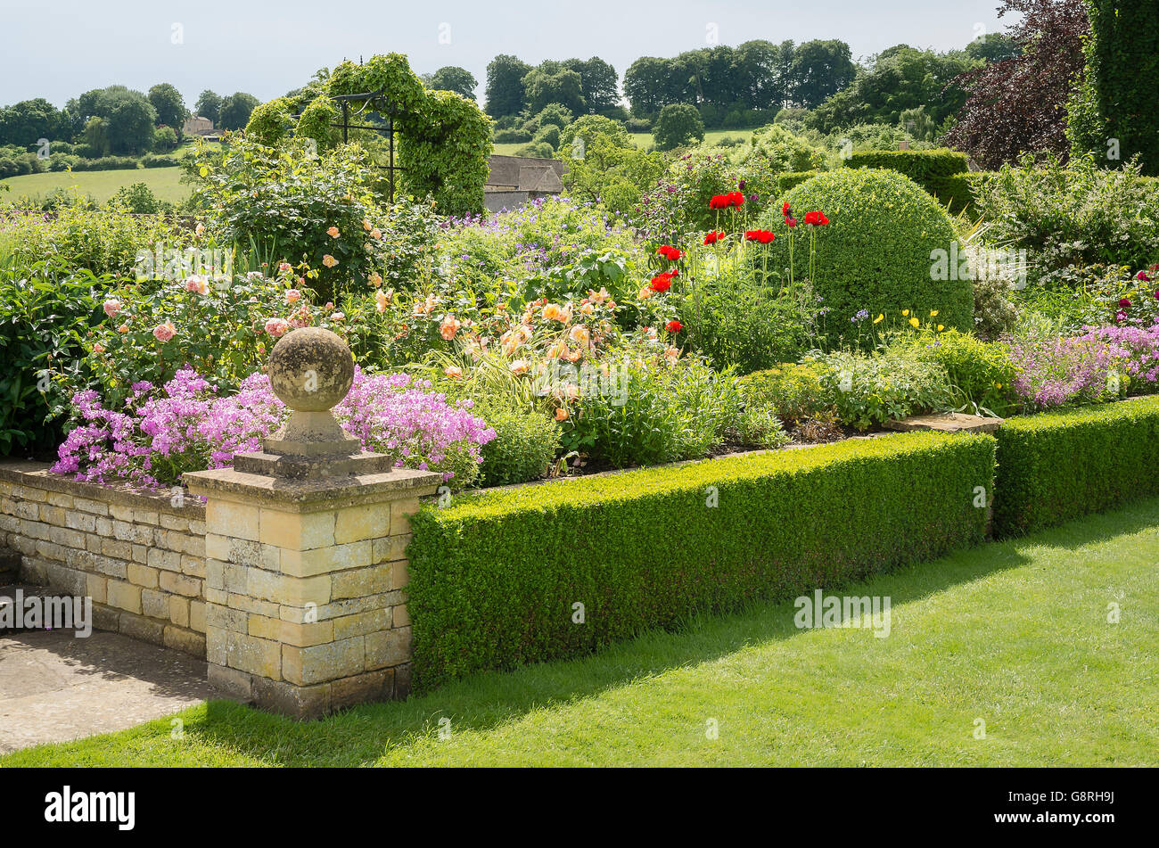 Raised herbaceous flower border in Bourton House garden Stock Photo