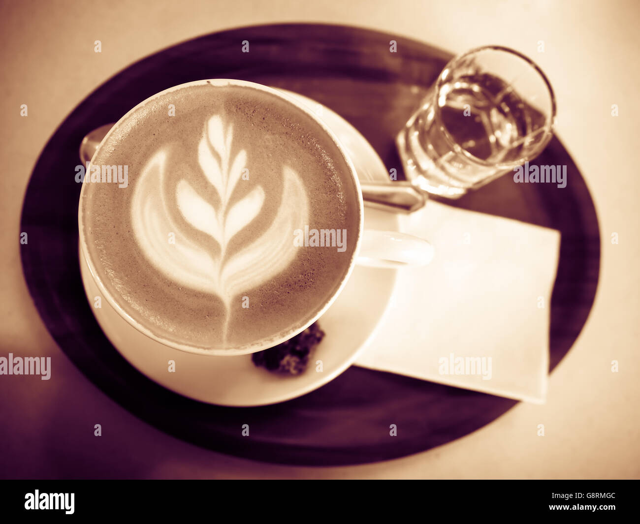 Cup of cappuccino in cafeteria toned Stock Photo