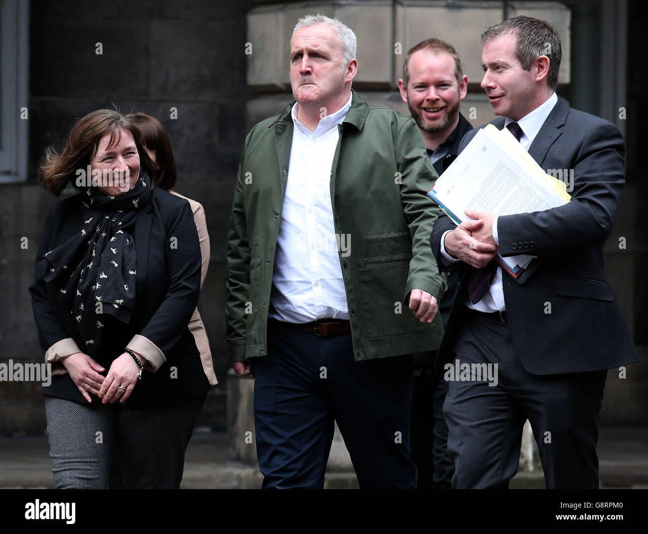 Jacqueline and Matthew McQuade (front left and centre) parents of Erin 18, who died along with her grandparents Jack Sweeney, 68, and his 69-year-old wife Lorraine in the Glasgow bin lorry crash leave the Parliament House in Edinburgh after a procedural hearing on bids for private prosecution of the driver Harry Clarke. Stock Photo