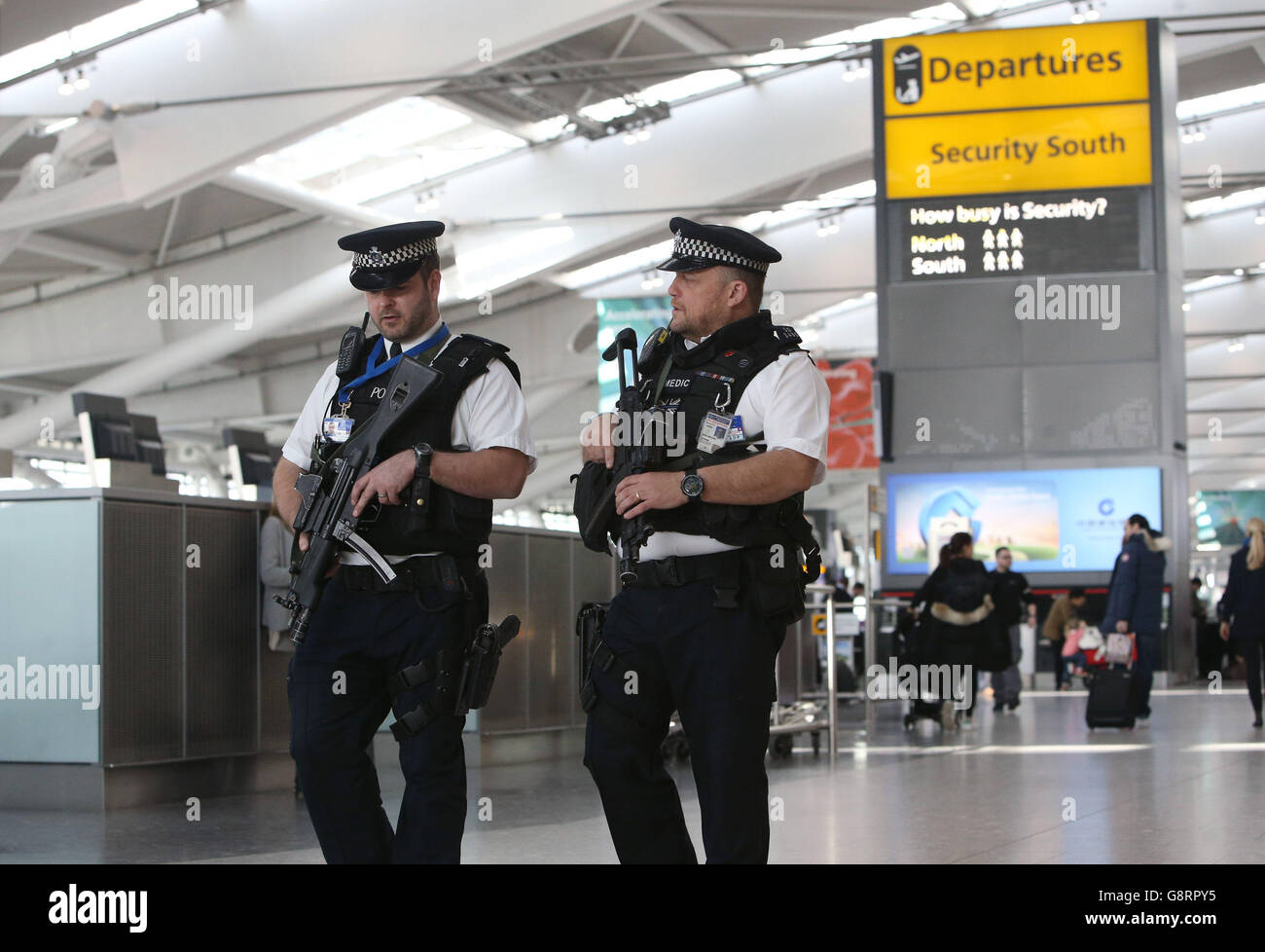 Armed police officers patrol inside Terminal 5 at Heathrow airport in