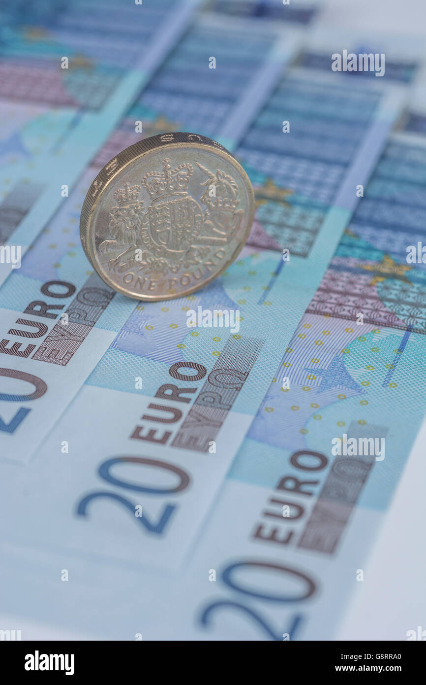 Brexit concept and Euro zone, monetary union, single market represented by some 20 Euro banknotes and old style UK Pound Sterling coin. Stock Photo