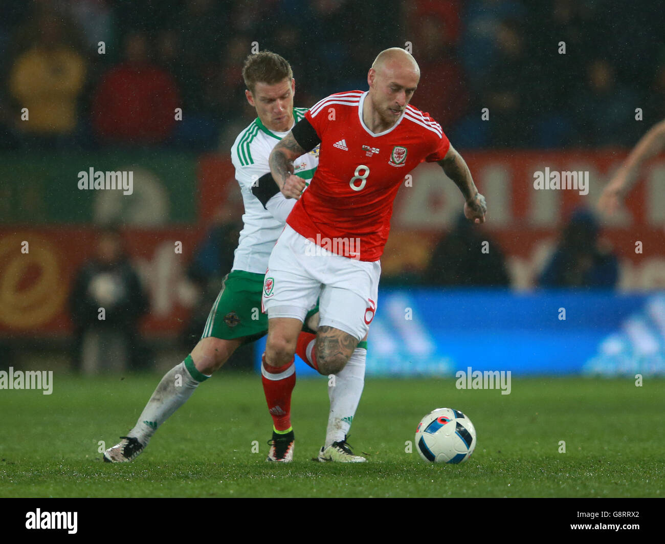 Wales's David Cotterill (right) and Northern Ireland's Steven Davis battle for the ball during the International Friendly at the Cardiff City Stadium, Cardiff. Stock Photo
