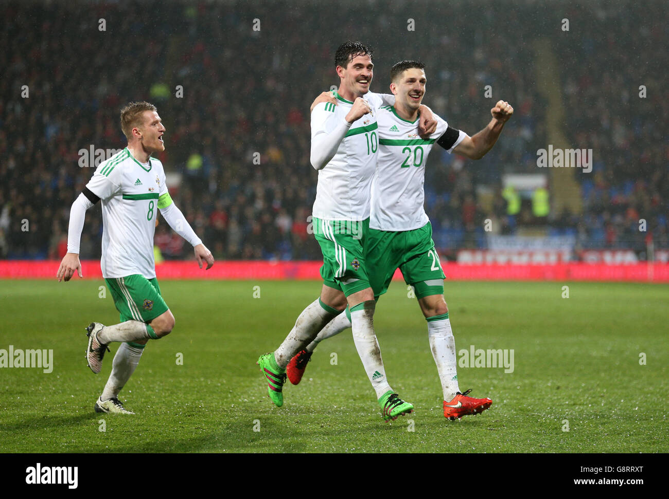 Northern Ireland's Craig Cathcart (right) celebrates scoring his side's first goal of the game during the International Friendly at the Cardiff City Stadium, Cardiff. Stock Photo