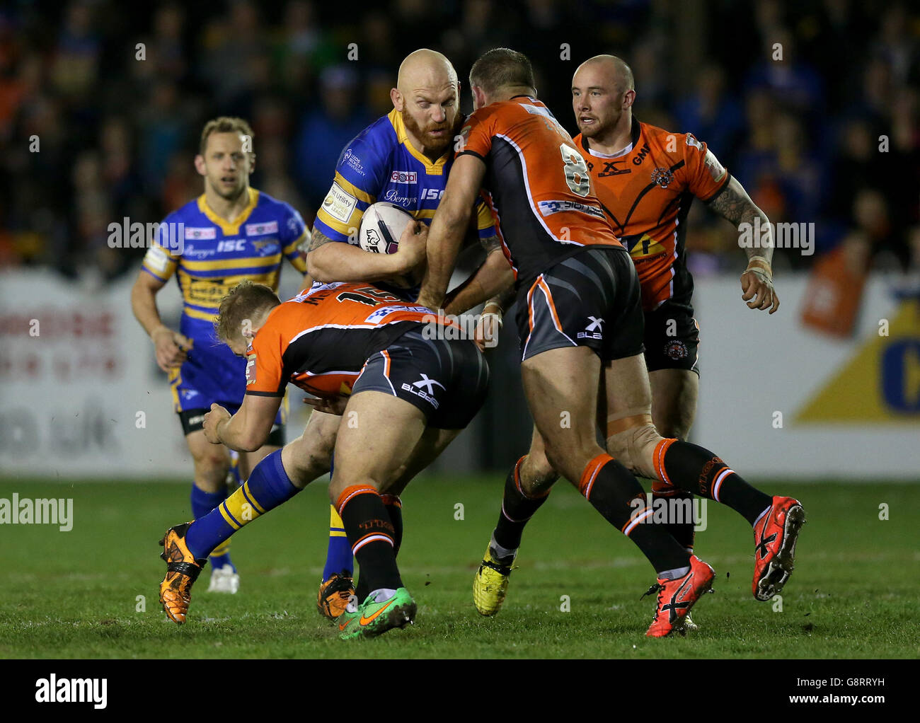Leeds Rhinos Keith Galloway is tackled by Castleford Tigers Paul McShane (left) and Andy Lynch (right), during the First Utility Super League match at the Mend-A-Hose Jungle, Castleford Stock Photo